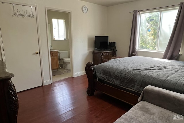 1941 Vassar St, Delano, CA 93215 - bedroom featuring multiple windows, dark wood-style flooring, baseboards, and ensuite bath