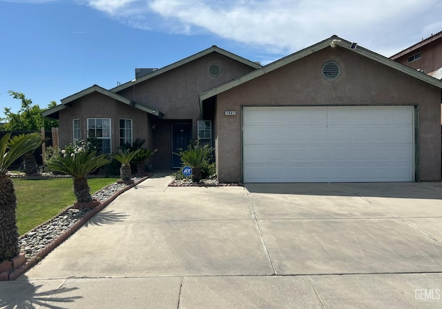 1941 Vassar St, Delano, CA 93215 - ranch-style house with driveway, stucco siding, and a garage