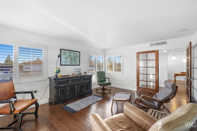 sitting room with french doors, dark wood-type flooring, visible vents, and baseboards