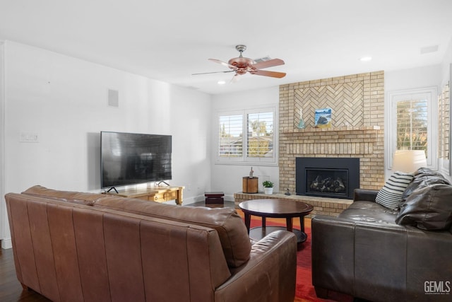 living room with recessed lighting, visible vents, a ceiling fan, a brick fireplace, and baseboards