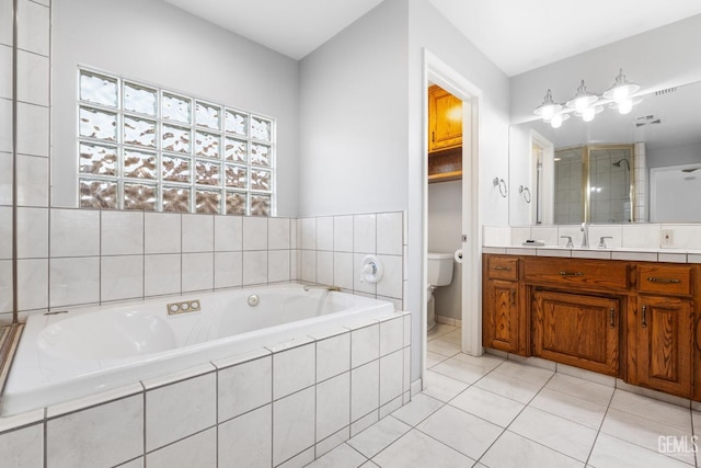 bathroom with toilet, vanity, a bath, tile patterned floors, and a stall shower