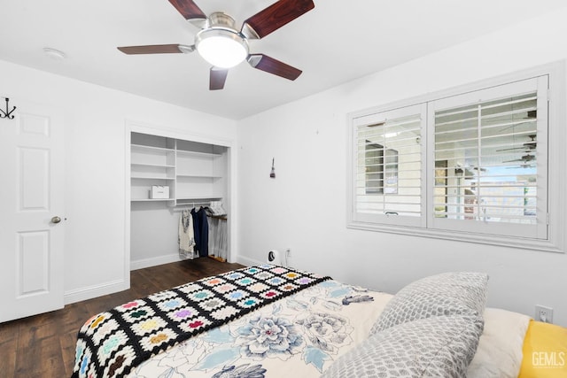 bedroom featuring ceiling fan, dark wood-type flooring, a closet, and baseboards