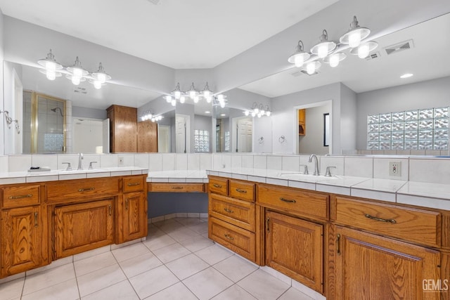 bathroom with tile patterned flooring, visible vents, and vanity