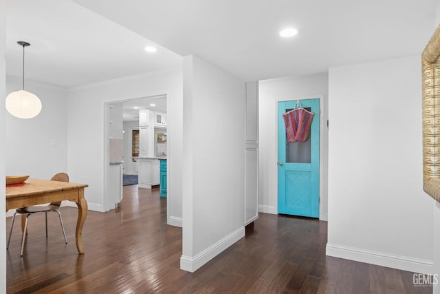 corridor with crown molding, baseboards, dark wood-style flooring, and recessed lighting