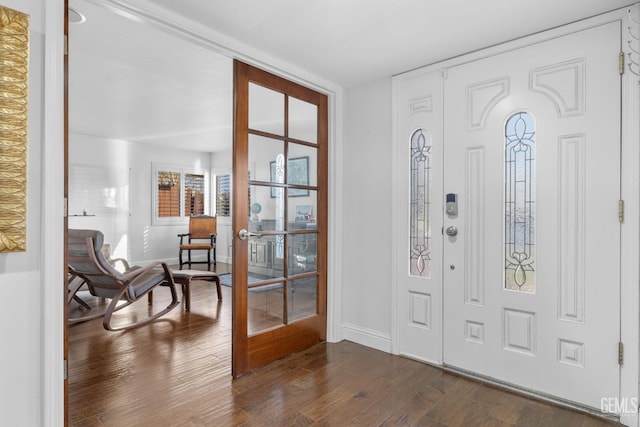 entryway with dark wood-style flooring, french doors, and baseboards