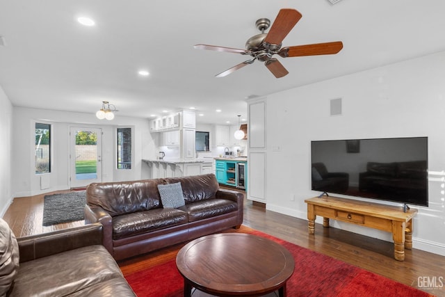 living area featuring baseboards, dark wood finished floors, ceiling fan, wine cooler, and recessed lighting