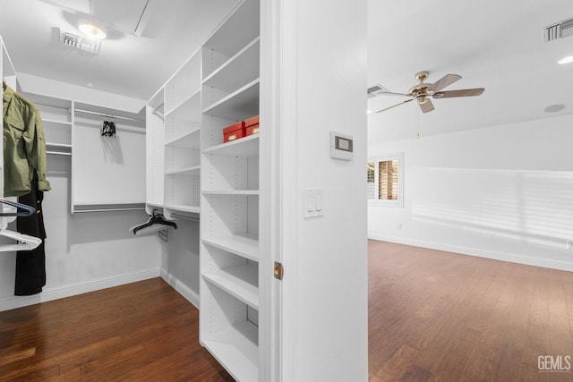 spacious closet featuring dark wood-style floors, attic access, and visible vents