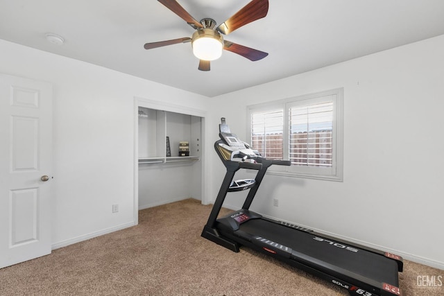 exercise room featuring baseboards, ceiling fan, and light colored carpet