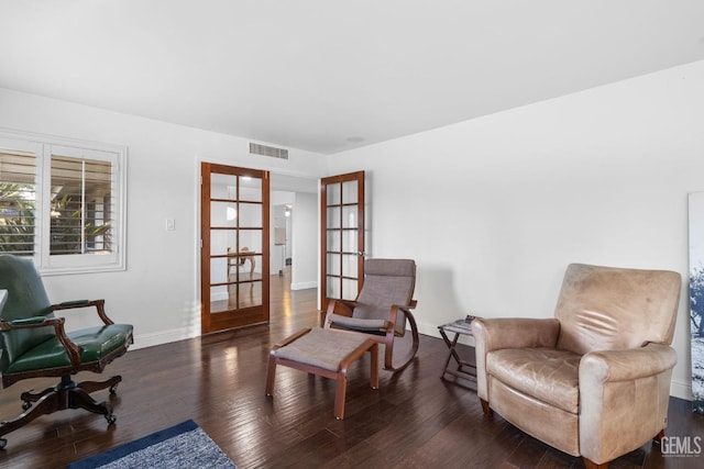 sitting room featuring french doors, dark wood-type flooring, visible vents, and baseboards