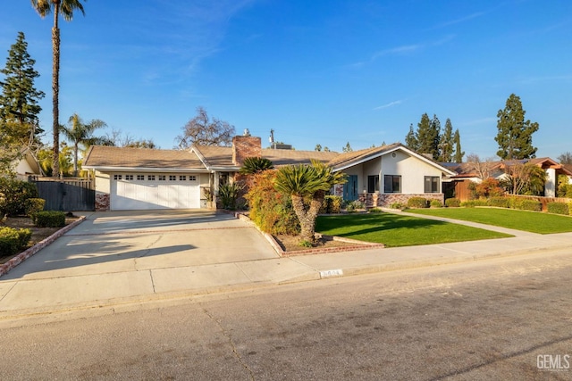 ranch-style home featuring driveway, a front lawn, an attached garage, and fence