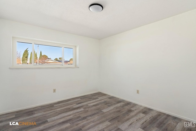 empty room with dark wood-type flooring