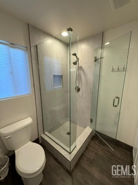 7009 Quailwood Dr, Bakersfield, CA 93309 - bathroom featuring wood finished floors and a stall shower