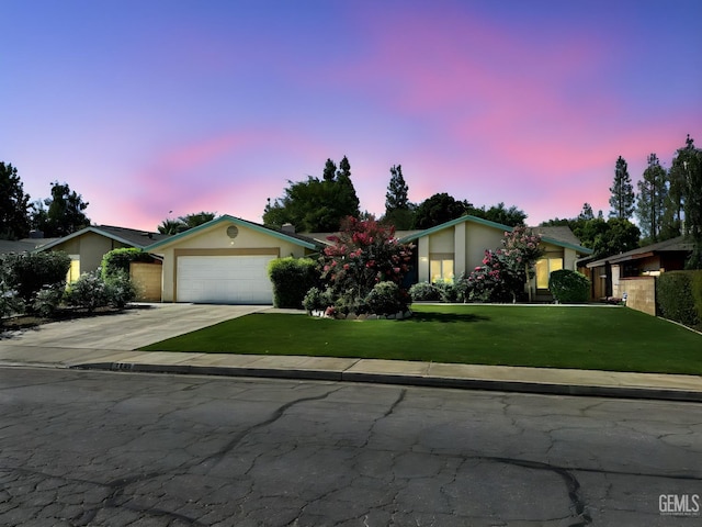 7009 Quailwood Dr, Bakersfield, CA 93309 - view of front of house with concrete driveway, a front yard, a garage, and stucco siding