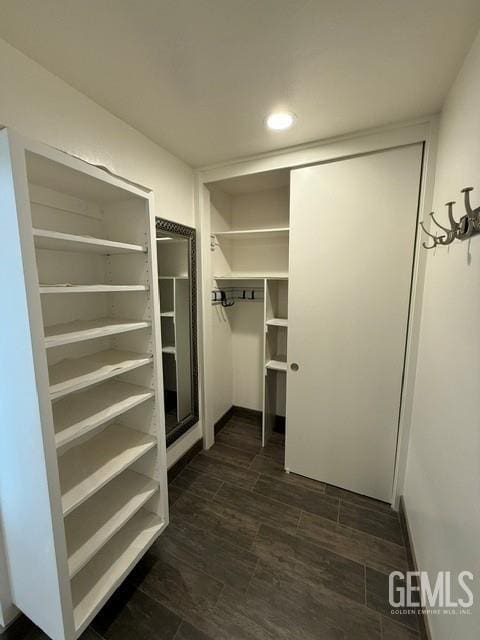 7009 Quailwood Dr, Bakersfield, CA 93309 - spacious closet featuring dark wood-type flooring