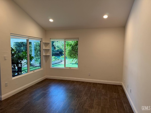 7009 Quailwood Dr, Bakersfield, CA 93309 - spare room featuring dark wood finished floors, recessed lighting, and vaulted ceiling