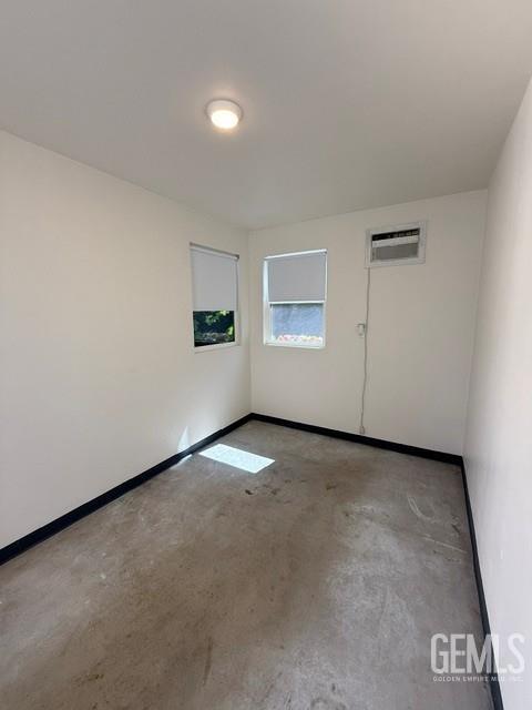 7009 Quailwood Dr, Bakersfield, CA 93309 - empty room with a wall mounted AC and concrete flooring