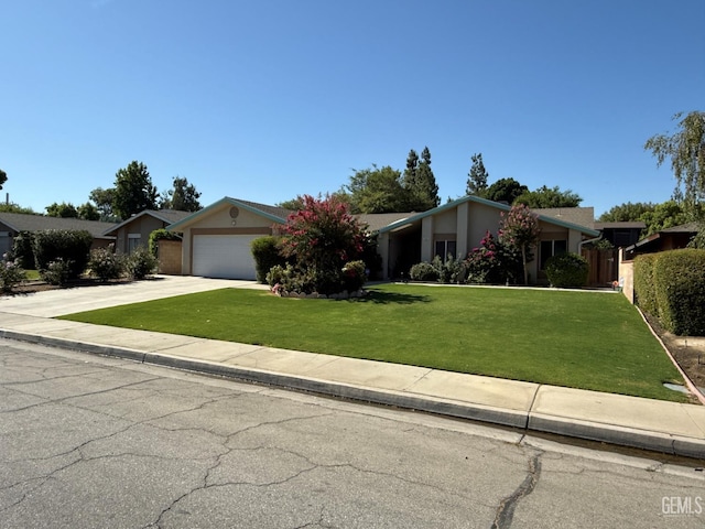 7009 Quailwood Dr, Bakersfield, CA 93309 - view of front facade with concrete driveway, an attached garage, and stucco siding