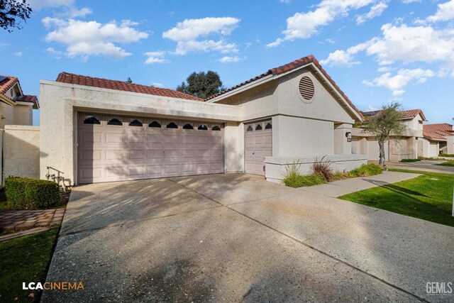 mediterranean / spanish home featuring a garage