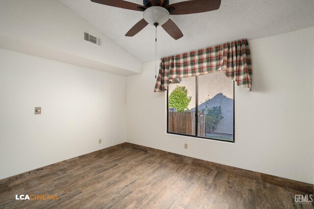 spare room featuring wood-type flooring, vaulted ceiling, ceiling fan, and a textured ceiling