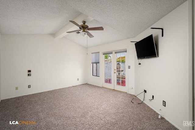 carpeted empty room featuring vaulted ceiling with beams, a textured ceiling, and ceiling fan