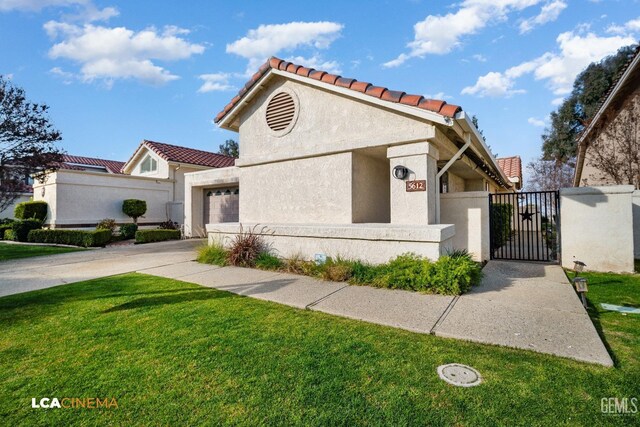 view of front of property with a garage and a front yard