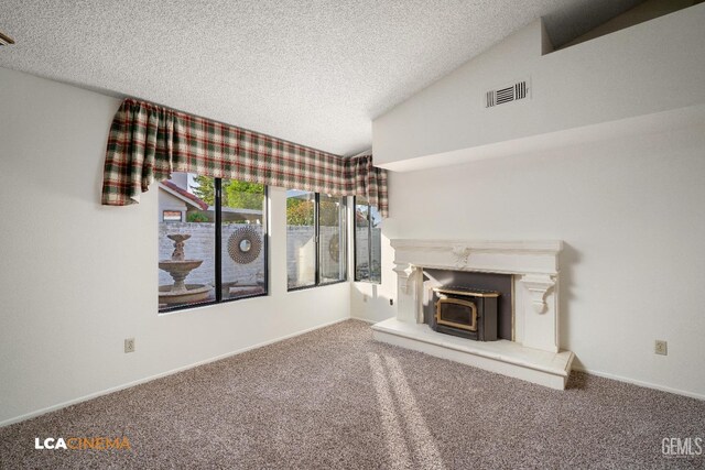 unfurnished living room featuring vaulted ceiling, a textured ceiling, and carpet