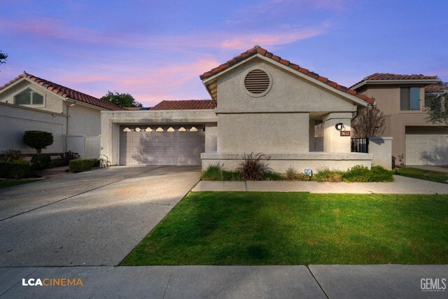 mediterranean / spanish-style house with a lawn