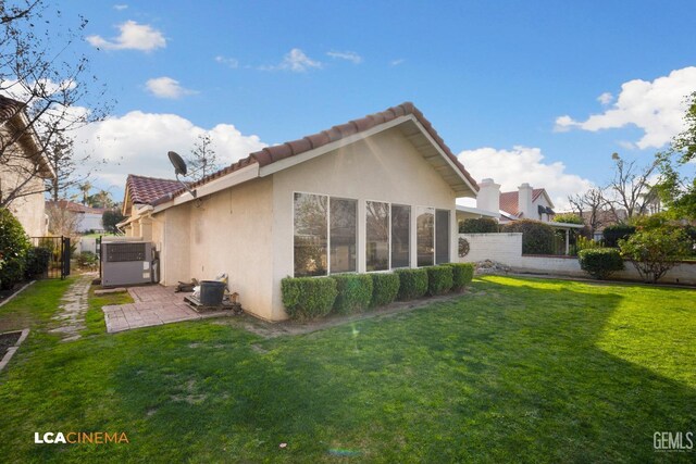 rear view of house with a yard