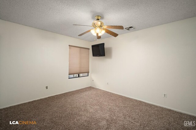 carpeted spare room featuring ceiling fan and a textured ceiling