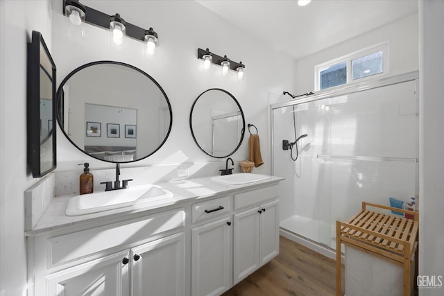 9642 Silver Falls Ln, Shafter, CA 93263 - full bathroom featuring double vanity, a shower stall, and wood finished floors