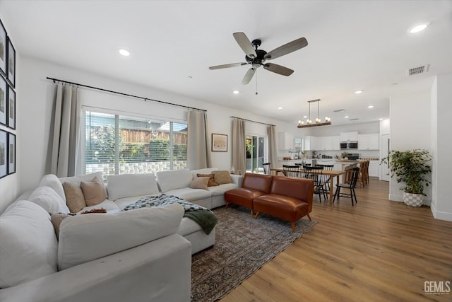 9642 Silver Falls Ln, Shafter, CA 93263 - living room with wood finished floors, ceiling fan, recessed lighting, and a chandelier