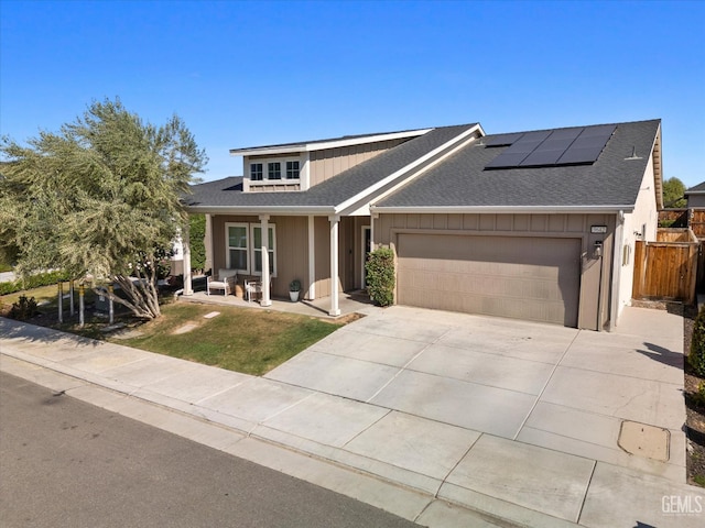 9642 Silver Falls Ln, Shafter, CA 93263 - view of front of property featuring roof mounted solar panels, a garage, driveway, and roof with shingles