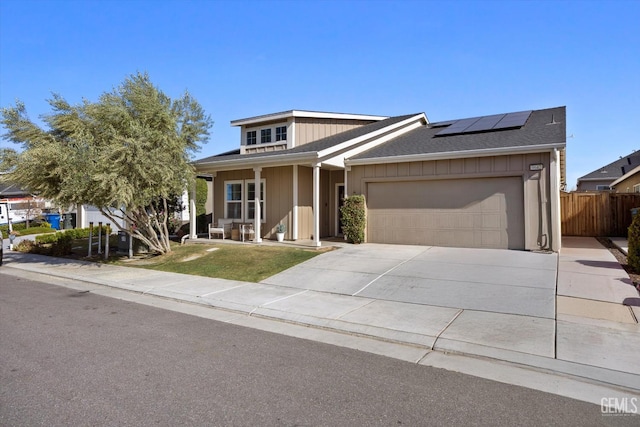 9642 Silver Falls Ln, Shafter, CA 93263 - view of front of property featuring a porch, solar panels, a garage, driveway, and roof with shingles