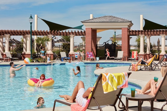 pool with a patio area, fence, and a pergola