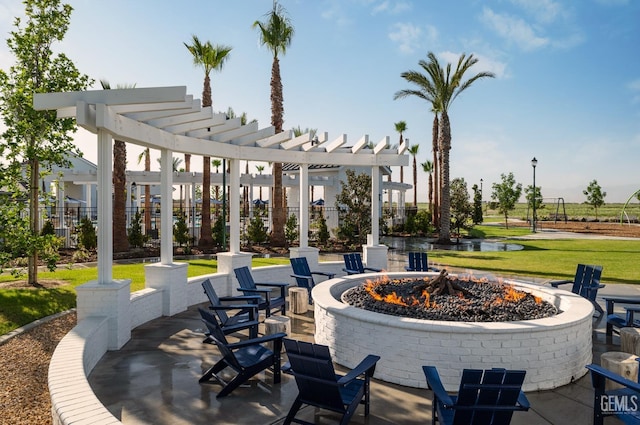 view of patio / terrace with a pergola and a fire pit