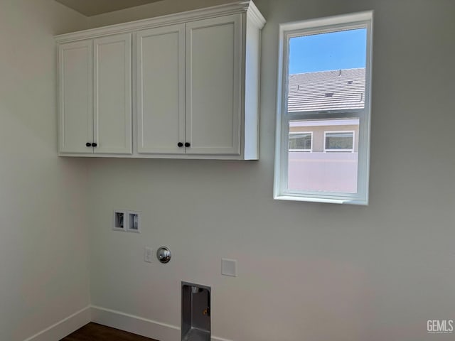 clothes washing area with baseboards, hookup for a washing machine, hookup for an electric dryer, cabinet space, and hookup for a gas dryer