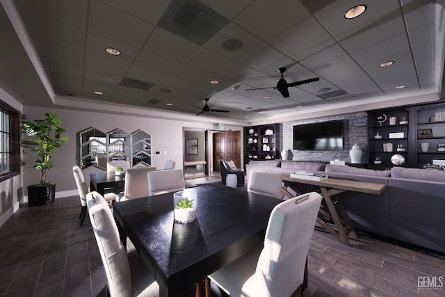 dining room with ceiling fan, a paneled ceiling, visible vents, a raised ceiling, and baseboards