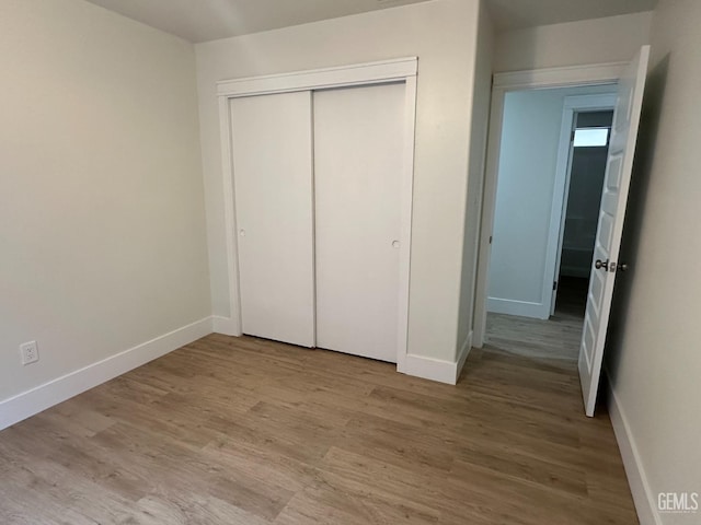 320 10th St, Mc Farland, CA 93250 - unfurnished bedroom with baseboards, a closet, and wood finished floors