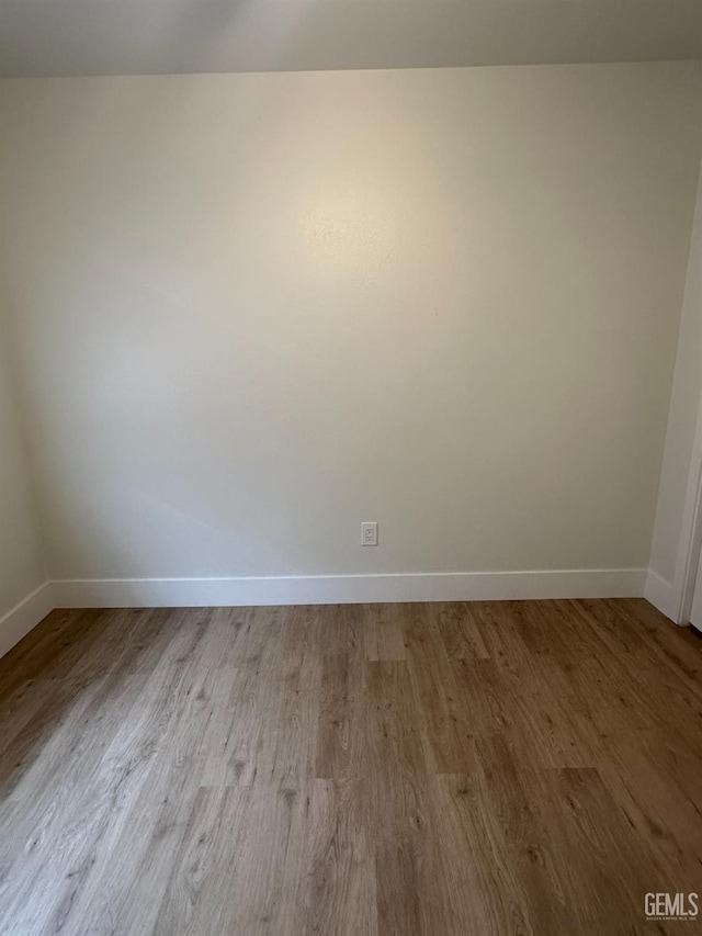 320 10th St, Mc Farland, CA 93250 - empty room with baseboards and wood finished floors