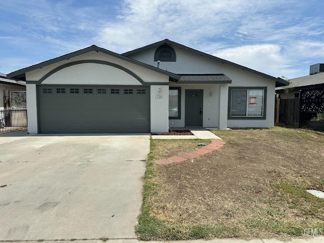 320 10th St, Mc Farland, CA 93250 - ranch-style home featuring a garage, fence, stucco siding, and concrete driveway