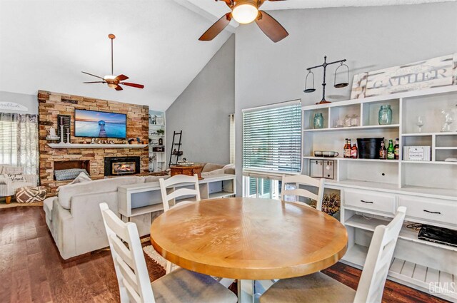 7701 Shetland Dr, Bakersfield, CA 93309 - dining area with ceiling fan, wood finished floors, a stone fireplace, and high vaulted ceiling