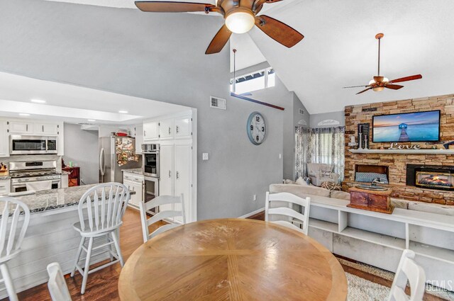 7701 Shetland Dr, Bakersfield, CA 93309 - dining area featuring a ceiling fan, high vaulted ceiling, a fireplace, light wood-type flooring, and recessed lighting