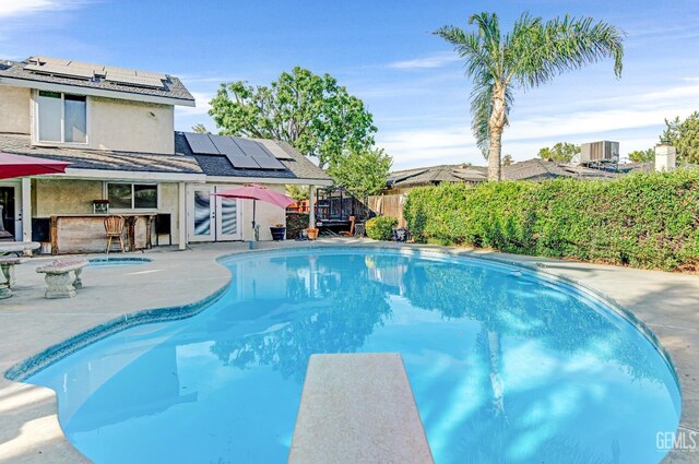 7701 Shetland Dr, Bakersfield, CA 93309 - view of pool with a diving board, a patio, a fenced backyard, and a wooden deck