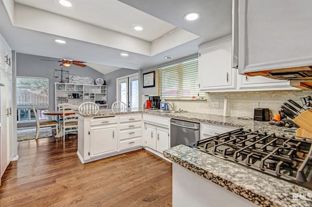 7701 Shetland Dr, Bakersfield, CA 93309 - kitchen with stainless steel dishwasher, a peninsula, ceiling fan, white cabinetry, and recessed lighting