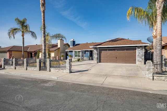 ranch-style house with concrete driveway, fence, a garage, and stone siding