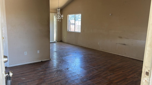 5610 Plute Pass St, Bakersfield, CA 93307 - unfurnished dining area featuring dark wood-type flooring, vaulted ceiling, and a chandelier