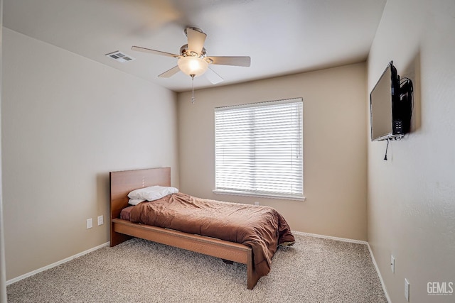 bedroom featuring visible vents, baseboards, and carpet