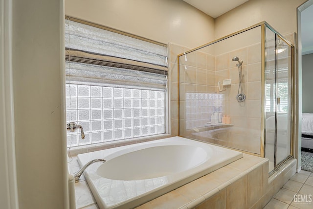 full bathroom with tile patterned flooring, a stall shower, and a garden tub