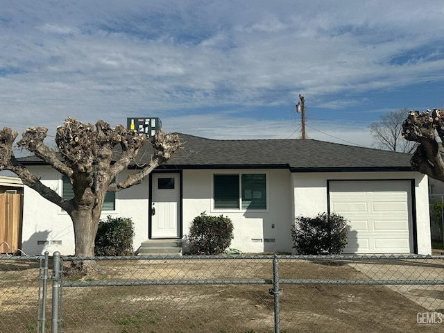 ranch-style house featuring a garage, roof with shingles, a fenced front yard, and stucco siding