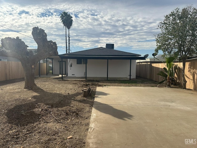 back of house featuring a fenced backyard and a patio